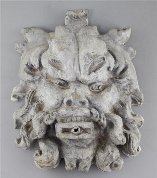An 18th century Green Man lead fountain head, 15 x 12in.